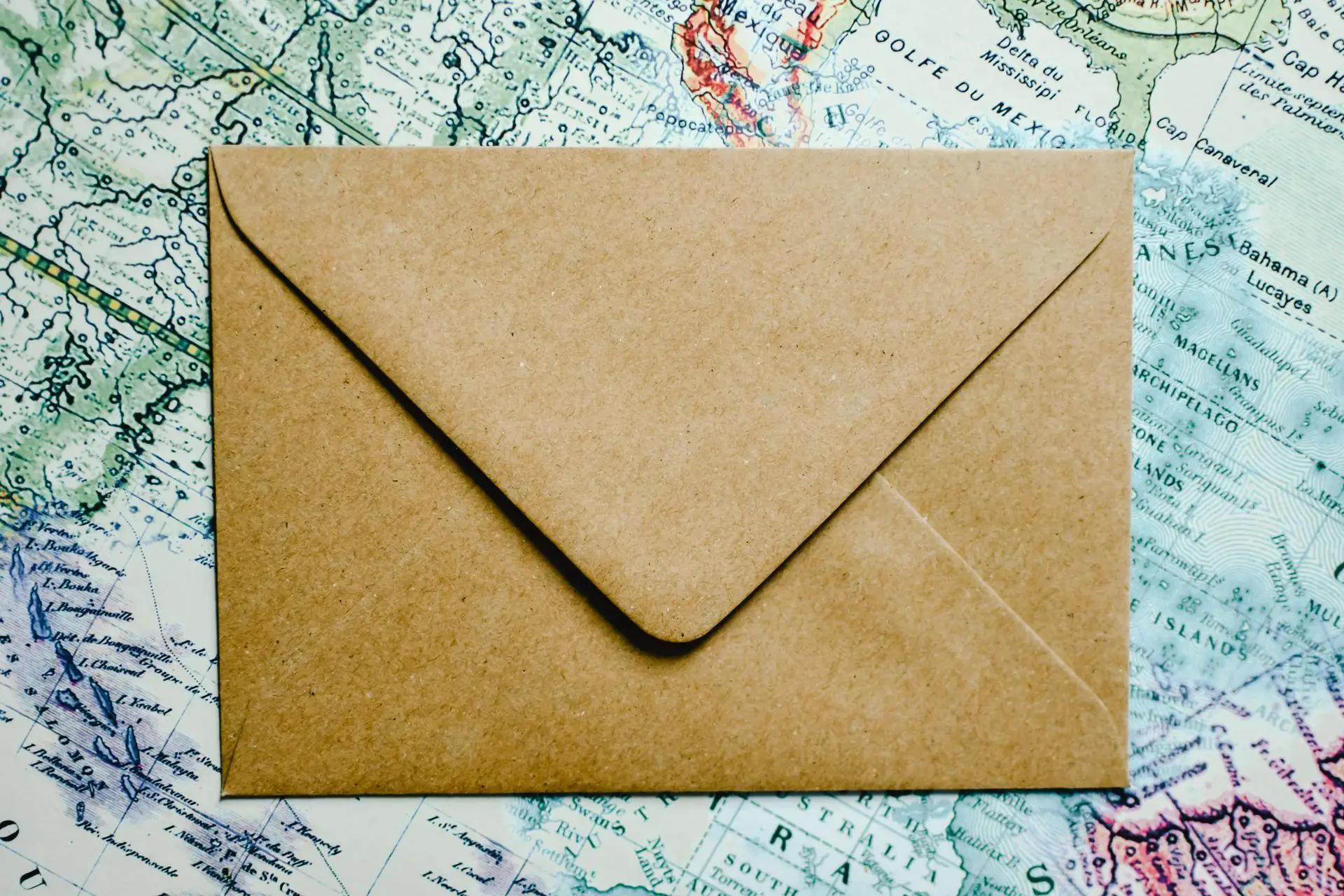An old paper map with an envelope resting on it